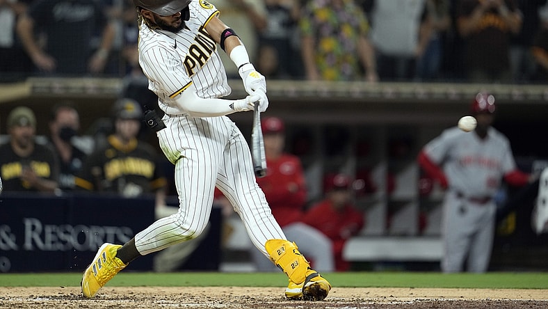 Jun 18, 2021; San Diego, California, USA;  San Diego Padres shortstop Fernando Tatis Jr. (23) hits a single against the Cincinnati Reds in the fourth inning at Petco Park. Mandatory Credit: Ray Acevedo-USA TODAY Sports