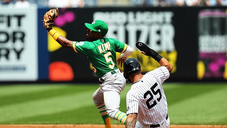 Jun 19, 2021; Bronx, New York, USA; New York Yankees shortstop Gleyber Torres (25) is forced out at second base by Oakland Athletics second baseman Tony Kemp (5) on the first part of a double play during the second inning at Yankee Stadium. Mandatory Credit: Andy Marlin-USA TODAY Sports
