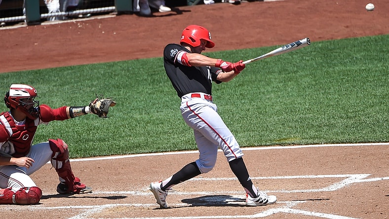 Jun 19, 2021; Omaha, Nebraska, USA;  NC State Wolfpack outfielder Jonny Butler (14) singles in two runs in the fourth inning against the Stanford Cardinal at TD Ameritrade Park. Mandatory Credit: Steven Branscombe-USA TODAY Sports