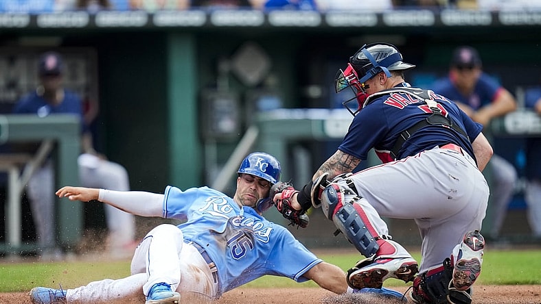 Jun 19, 2021; Kansas City, Missouri, USA; Kansas City Royals right fielder Whit Merrifield (15) is tagged out at home by Boston Red Sox catcher Christian Vazquez (7) during the first inning at Kauffman Stadium. Mandatory Credit: Jay Biggerstaff-USA TODAY Sports