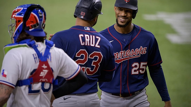 Jun 19, 2021; Arlington, Texas, USA; Minnesota Twins center fielder Byron Buxton (25) and designated hitter Nelson Cruz (23) celebrate Cruz hitting a two run home run against the Texas Rangers during the fourth inning at Globe Life Field. Mandatory Credit: Jerome Miron-USA TODAY Sports