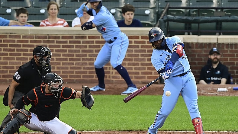 Jun 19, 2021; Baltimore, Maryland, USA;  Toronto Blue Jays designated hitter Vladimir Guerrero Jr. (27) hits as rbi double in the ninth inning against the Baltimore Orioles at Oriole Park at Camden Yards. Mandatory Credit: Tommy Gilligan-USA TODAY Sports