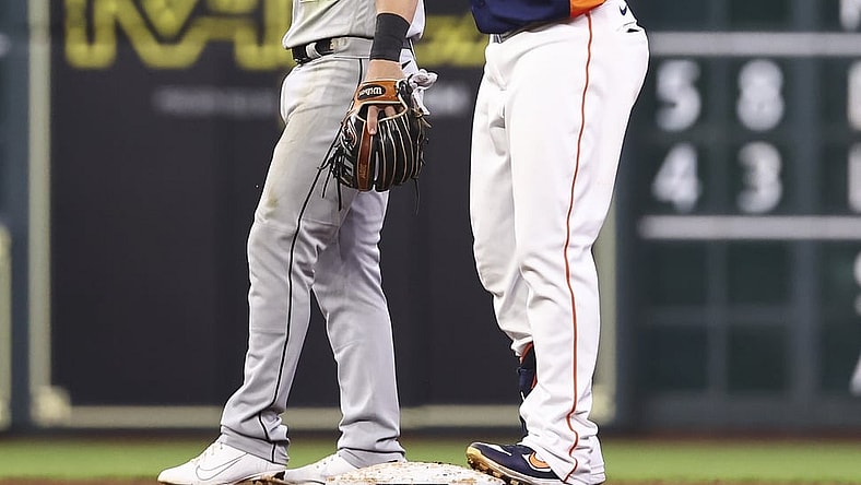 Jun 19, 2021; Houston, Texas, USA; Chicago White Sox second baseman Danny Mendick (20) looks on as Houston Astros designated hitter Michael Brantley (23) gives a thumbs up after hitting an RBI double during the fourth inning at Minute Maid Park. Mandatory Credit: Troy Taormina-USA TODAY Sports