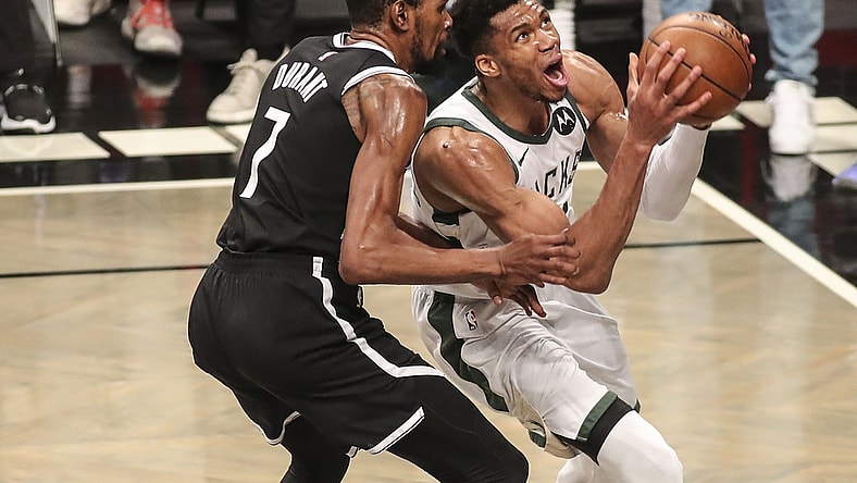 Jun 19, 2021; Brooklyn, New York, USA; Milwaukee Bucks forward Giannis Antetokounmpo (34) drives past Brooklyn Nets forward Kevin Durant (7) in the third quarter during game seven in the second round of the 2021 NBA Playoffs at Barclays Center. Mandatory Credit: Wendell Cruz-USA TODAY Sports