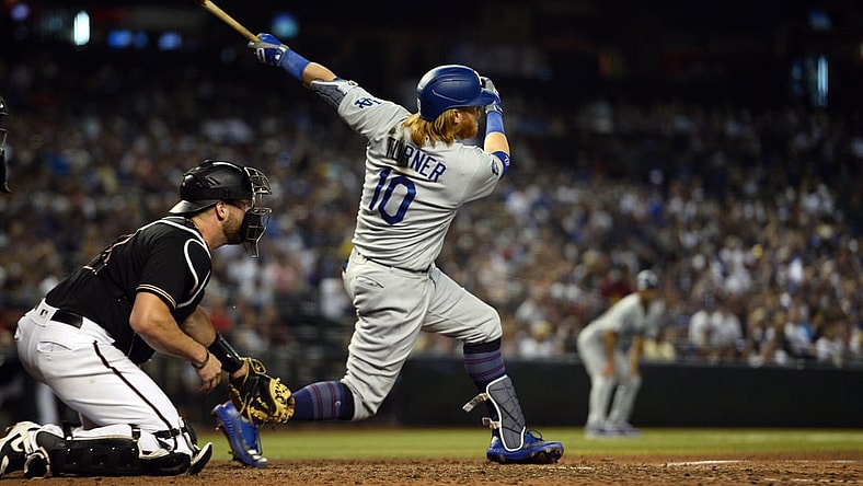 Jun 19, 2021; Phoenix, Arizona, USA; Los Angeles Dodgers third baseman Justin Turner (10) hits three RBI double against the Arizona Diamondbacks during the sixth inning at Chase Field. Mandatory Credit: Joe Camporeale-USA TODAY Sports