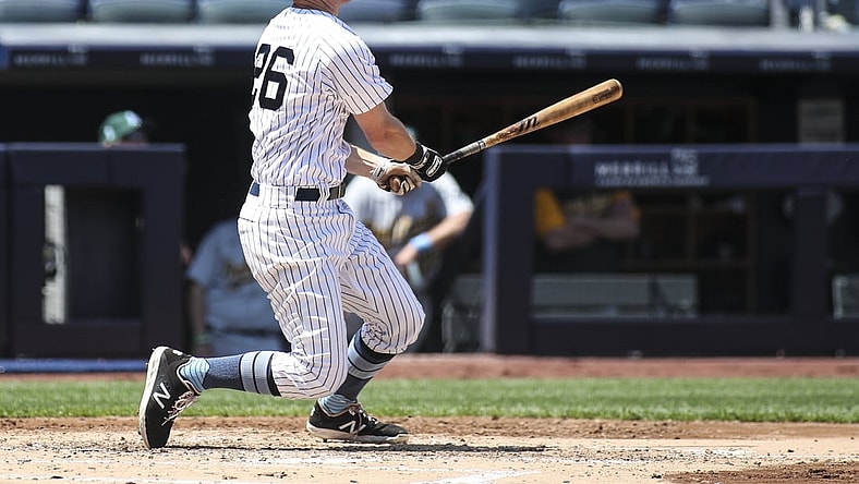 Jun 20, 2021; Bronx, New York, USA; New York Yankees second baseman DJ LeMahieu (26) hits a double in the third inning against the Oakland Athletics at Yankee Stadium. Mandatory Credit: Wendell Cruz-USA TODAY Sports
