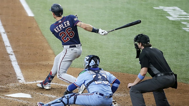Jun 20, 2021; Arlington, Texas, USA; Minnesota Twins right fielder Max Kepler (26) follows through on a swing for a two-run single in the third inning against the Texas Rangers at Globe Life Field. Mandatory Credit: Tim Heitman-USA TODAY Sports