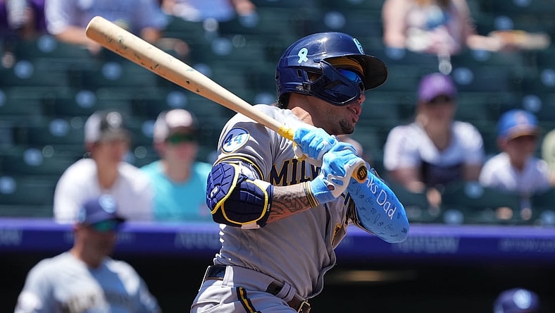 Jun 20, 2021; Denver, Colorado, USA; Milwaukee Brewers second baseman Kolten Wong (16) singles in the first inning against the Colorado Rockies at Coors Field. Mandatory Credit: Ron Chenoy-USA TODAY Sports