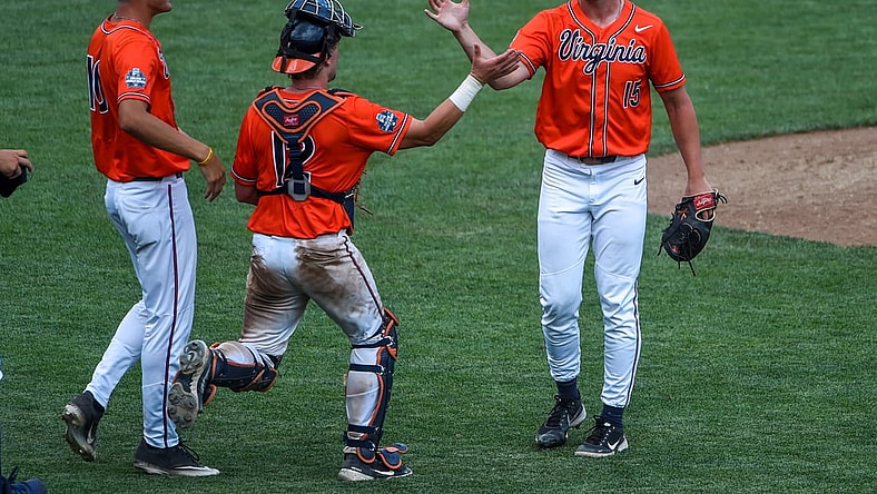 Jun 20, 2021; Omaha, Nebraska, USA; Virginia Cavaliers pitcher Matt Wyatt (15) celebrates the win with catcher Logan Michaels (12) against the Tennessee Volunteers at TD Ameritrade Park. Mandatory Credit: Steven Branscombe-USA TODAY Sports