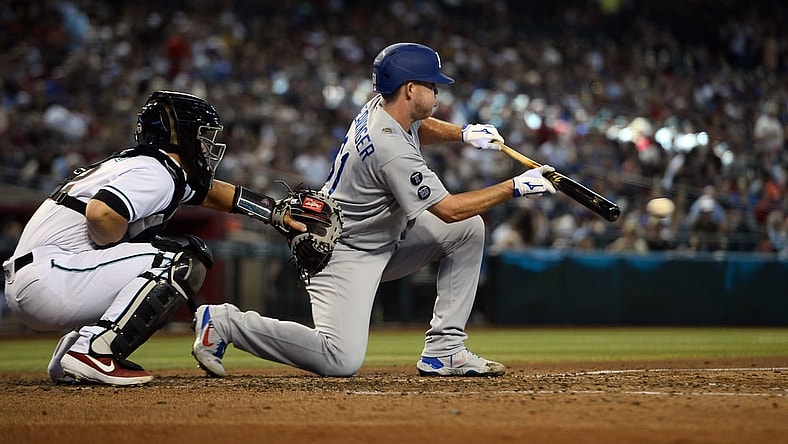 Jun 20, 2021; Phoenix, Arizona, USA; Los Angeles Dodgers relief pitcher Garrett Cleavinger puts down a fielder's choice RBI bunt against the Arizona Diamondbacks during the fifth inning at Chase Field. Mandatory Credit: Joe Camporeale-USA TODAY Sports