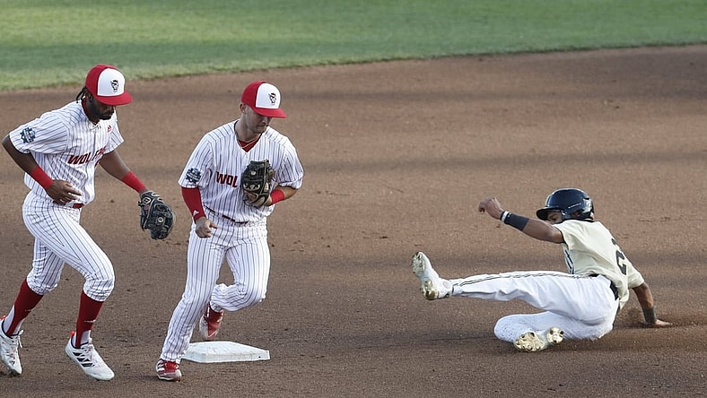 Jun 21, 2021; Omaha, Nebraska, USA;  NC State Wolfpack second baseman J.T. Jarrett (15) tags out Vanderbilt Commodores left fielder Javier Vaz (2) at TD Ameritrade Park. Mandatory Credit: Bruce Thorson-USA TODAY Sports