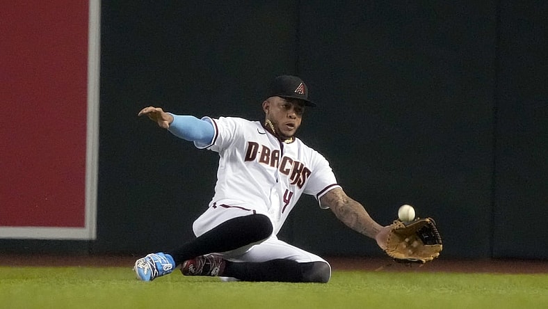 Jun 21, 2021; Phoenix, Arizona, USA; Arizona Diamondbacks second baseman Ketel Marte (4) makes the sliding catch for an out against the Milwaukee Brewers in the fourth inning at Chase Field. Mandatory Credit: Rick Scuteri-USA TODAY Sports