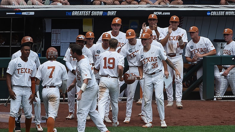 Jun 22, 2021; Omaha, Nebraska, USA; The Texas Longhorns bench celebrates with outfielder Douglas Hodo (7) and infielder Mitchell Daly (19) after scoring in the fourth inning against the Tennessee Volunteers at TD Ameritrade Park. Mandatory Credit: Steven Branscombe-USA TODAY Sports