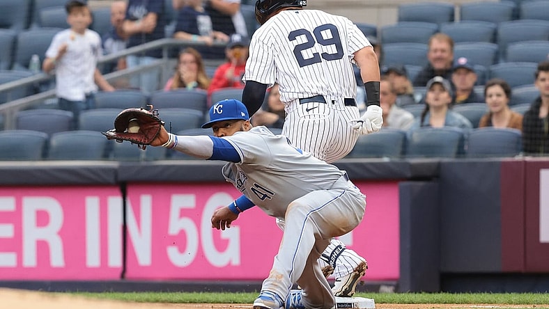 Jun 22, 2021; Bronx, New York, USA; New York Yankees third baseman Gio Urshela (29) beats the throw caught by Kansas City Royals first baseman Carlos Santana (41) during the first inning at Yankee Stadium. Mandatory Credit: Vincent Carchietta-USA TODAY Sports