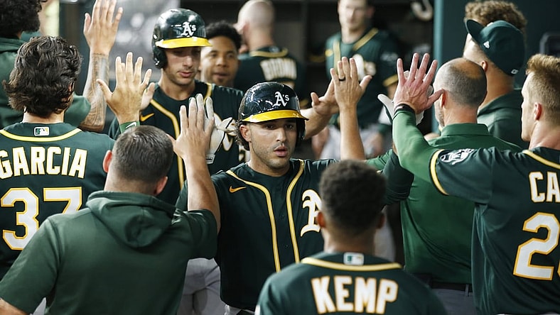 Jun 22, 2021; Arlington, Texas, USA; Oakland Athletics designated hitter Ramon Laureano (22) is congratulated by his teammates after hitting a home run in the second inning against the Texas Rangers at Globe Life Field. Mandatory Credit: Tim Heitman-USA TODAY Sports