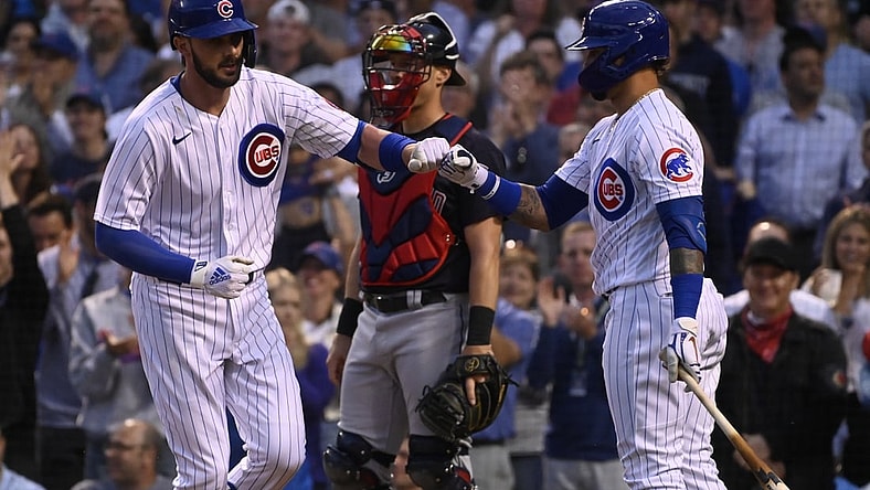 Jun 22, 2021; Chicago, Illinois, USA;  Chicago Cubs first baseman Kris Bryant (left) fist bumps shortstop Javier Baez (9) after hitting a home run against the Cleveland Indians during the fourth inning at Wrigley Field. Mandatory Credit: Matt Marton-USA TODAY Sports