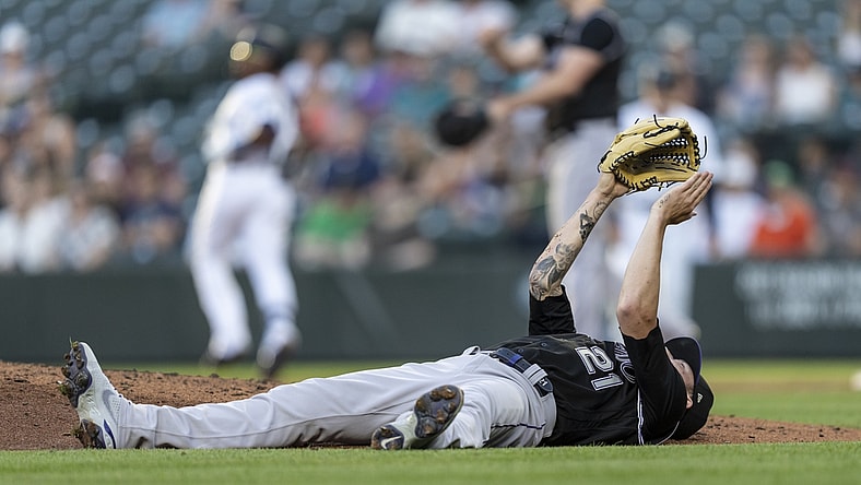 Jun 22, 2021; Seattle, Washington, USA;  Colorado Rockies starting pitcher Kyle Freeland reacts while laying on his back after dodging a ball hit by Seattle Mariners left fielder Shed Long Jr. (4) during the third inning of a game at T-Mobile Park. Mandatory Credit: Stephen Brashear-USA TODAY Sports