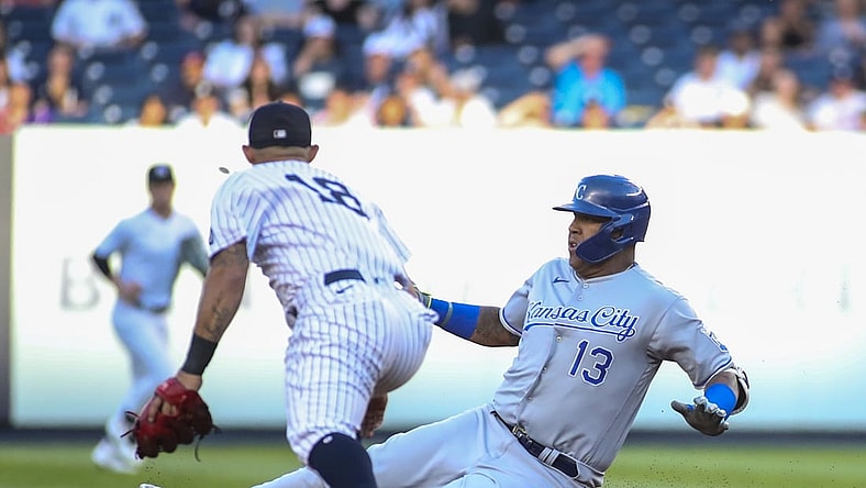 Jun 23, 2021; Bronx, New York, USA; Kansas City Royals catcher Salvador Perez (13) slides into second base after hitting a double in the first inning against the New York Yankees at Yankee Stadium. Mandatory Credit: Wendell Cruz-USA TODAY Sports