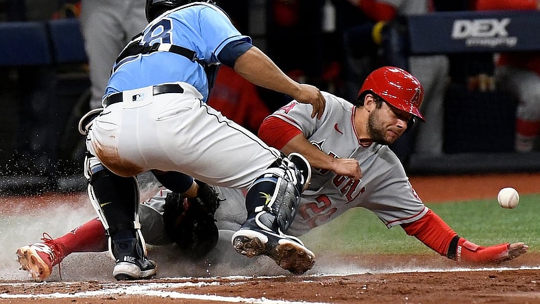 Jun 25, 2021; St. Petersburg, Florida, USA;  Los Angeles Angels second baseman David Fletcher (22) scores a run as Tampa Bay Rays catcher Francisco Mejia (28) drops the balls in the third inning at Tropicana Field. Mandatory Credit: Jonathan Dyer-USA TODAY Sports