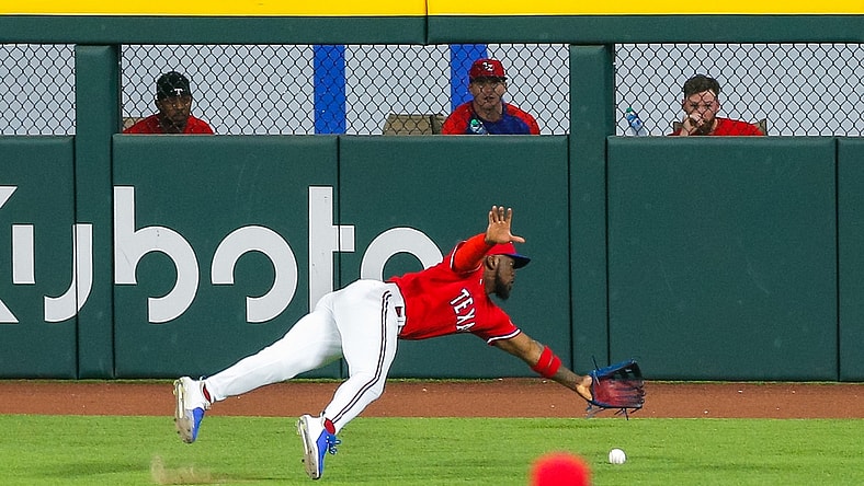 Jun 25, 2021; Arlington, Texas, USA; Texas Rangers center fielder Adolis Garcia (53) dives for a ball during the third inning against the Kansas City Royals at Globe Life Field. Mandatory Credit: Andrew Dieb-USA TODAY Sports