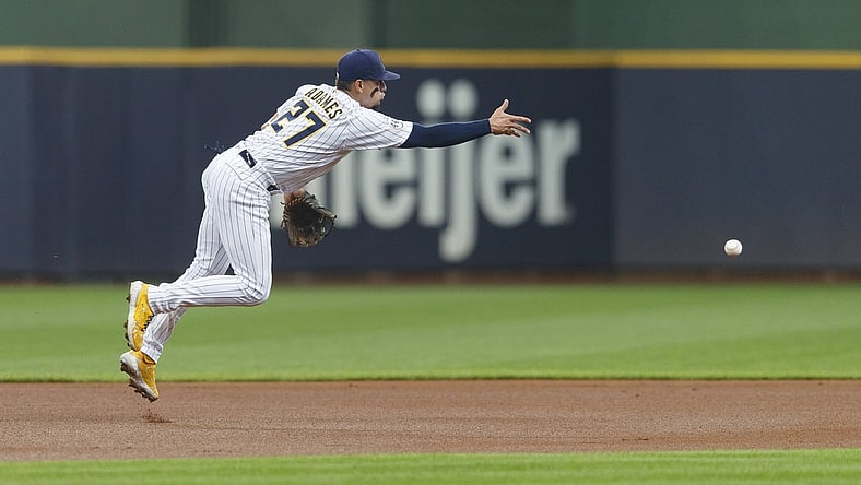 Jun 26, 2021; Milwaukee, Wisconsin, USA;  Milwaukee Brewers shortstop Willy Adames (27) tosses tosses the ball to second base during the first inning against the Colorado Rockies at American Family Field. Mandatory Credit: Jeff Hanisch-USA TODAY Sports