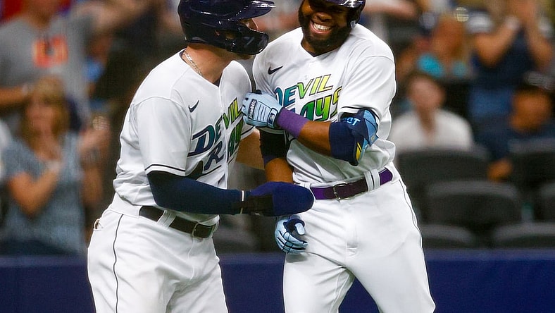 Jun 26, 2021; St. Petersburg, Florida, USA;  Tampa Bay Rays designated hitter Austin Meadows (17) congratulates  right fielder Manuel Margot (13) after hitting a two run home run in the second inning against the Los Angeles Angels Tropicana Field. Mandatory Credit: Nathan Ray Seebeck-USA TODAY Sports