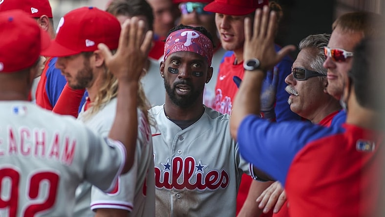 Jun 26, 2021; New York City, New York, USA;  Philadelphia Phillies left fielder Andrew McCutchen (22) is greeted in the dugout after scoring in the second inning against the New York Mets at Citi Field. Mandatory Credit: Wendell Cruz-USA TODAY Sports