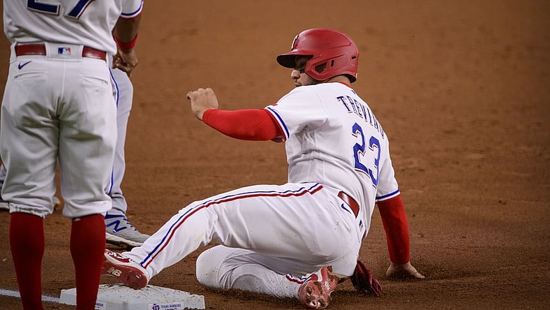 Jun 26, 2021; Arlington, Texas, USA; Texas Rangers catcher Jose Trevino (23) slides into third base during the second inning against the Kansas City Royals at Globe Life Field. Mandatory Credit: Jerome Miron-USA TODAY Sports