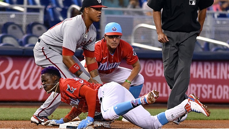 Jun 26, 2021; Miami, Florida, USA; Miami Marlins second baseman Jazz Chisholm Jr. (2) dives into third base as Washington Nationals third baseman Starlin Castro (13) looks on during the first inning at loanDepot Park. Mandatory Credit: Jim Rassol-USA TODAY Sports