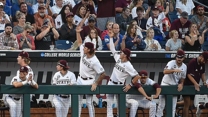 Jun 26, 2021; Omaha, Nebraska, USA; The Mississippi State Bulldogs bench leads the cheers in the ninth inning against the Texas Longhorns at TD Ameritrade Park. Mandatory Credit: Steven Branscombe-USA TODAY Sports