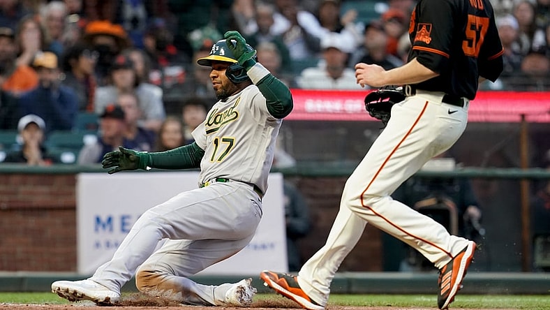 Jun 26, 2021; San Francisco, California, USA; Oakland Athletics shortstop Elvis Andrus (17) scores a run on a wild pitch against the San Francisco Giants in the third inning at Oracle Park. Mandatory Credit: Cary Edmondson-USA TODAY Sports