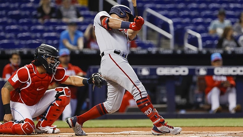 Jun 27, 2021; Miami, Florida, USA; Washington Nationals left fielder Kyle Schwarber (12) connects for a base hit against the Miami Marlins during the first inning at loanDepot Park. Mandatory Credit: Sam Navarro-USA TODAY Sports