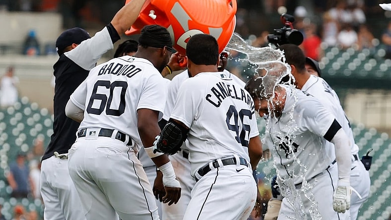 Jun 27, 2021; Detroit, Michigan, USA;  Detroit Tigers left fielder Robbie Grossman (8) is congratulated by teammates after he bunts in the winning run tenth inning against the Houston Astros at Comerica Park. Mandatory Credit: Rick Osentoski-USA TODAY Sports