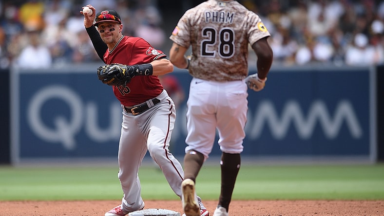 Jun 27, 2021; San Diego, California, USA; Arizona Diamondbacks shortstop Nick Ahmed (13) forces out San Diego Padres left fielder Tommy Pham (28) at second base before throwing to first base during the third inning at Petco Park. Mandatory Credit: Orlando Ramirez-USA TODAY Sports