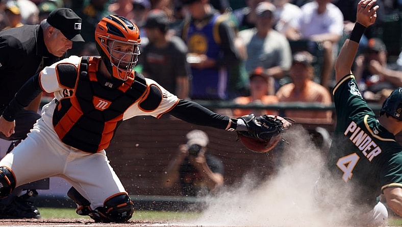 Jun 27, 2021; San Francisco, California, USA; San Francisco Giants catcher Buster Posey (28) misses a tag as Oakland Athletics left fielder Chad Pinder (4) scores a run during the sixth inning at Oracle Park. Mandatory Credit: Darren Yamashita-USA TODAY Sports