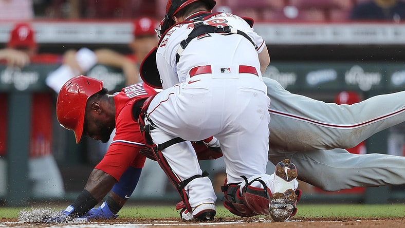 Jun 28, 2021; Cincinnati, Ohio, USA; Philadelphia Phillies center fielder Odubel Herrera (37) is tagged out at home by Cincinnati Reds catcher Tucker Barnhart (16) during the first inning at Great American Ball Park. Mandatory Credit: David Kohl-USA TODAY Sports