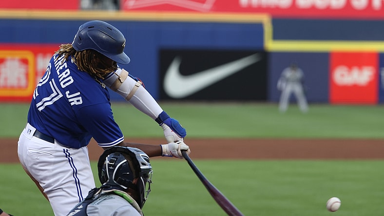 Jun 29, 2021; Buffalo, New York, USA;  Toronto Blue Jays first baseman Vladimir Guerrero Jr. (27) gets a base hit during the third inning against the Seattle Mariners at Sahlen Field. Mandatory Credit: Timothy T. Ludwig-USA TODAY Sports