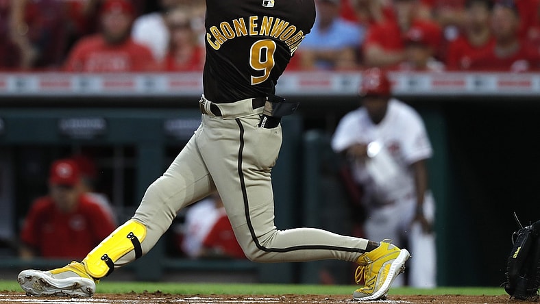 Jun 29, 2021; Cincinnati, Ohio, USA; San Diego Padres second baseman Jake Cronenworth (9) hits an RBI triple against the Cincinnati Reds during the first inning at Great American Ball Park. Mandatory Credit: David Kohl-USA TODAY Sports