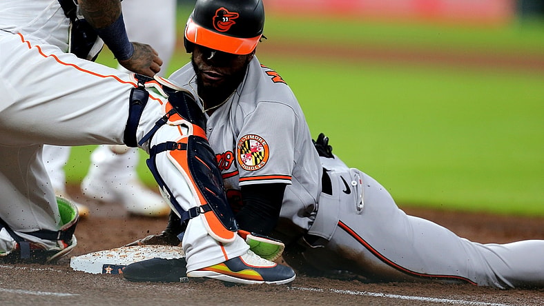 Jun 29, 2021; Houston, Texas, USA; Baltimore Orioles center fielder Cedric Mullins (31) slides into first to avoid a pickoff attempt against the Houston Astros during the third inning at Minute Maid Park. Mandatory Credit: Erik Williams-USA TODAY Sports