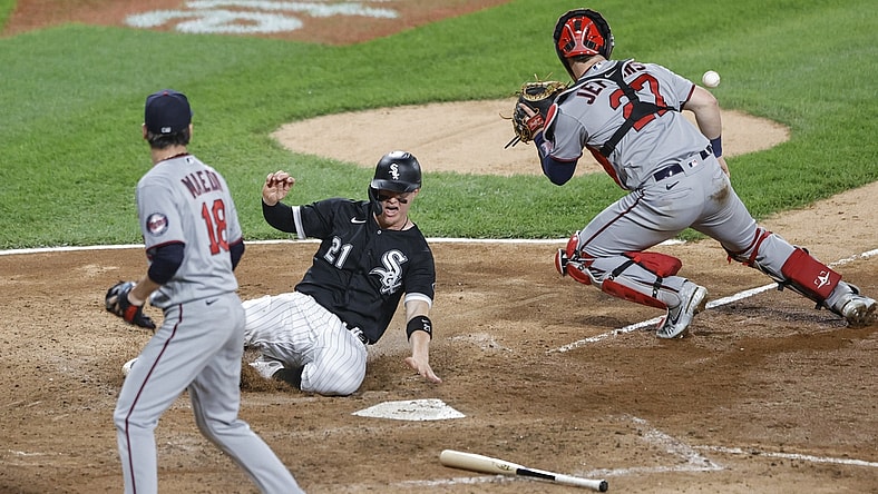 Jun 29, 2021; Chicago, Illinois, USA; Chicago White Sox catcher Zack Collins (21) scores a run as Minnesota Twins catcher Ryan Jeffers (27) waits for the ball during the fifth inning at Guaranteed Rate Field. Mandatory Credit: Kamil Krzaczynski-USA TODAY Sports