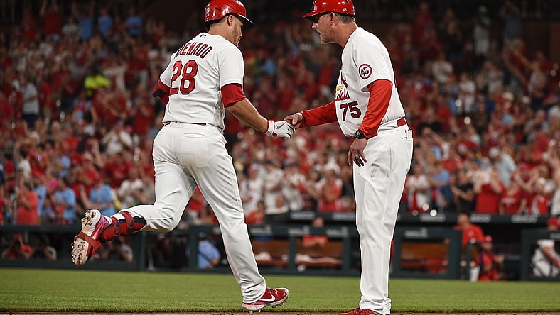 Jun 29, 2021; St. Louis, Missouri, USA; St. Louis Cardinals third baseman Nolan Arenado (28) is congratulated by third base coach Ron 'Pop' Warner (75) after hitting a two run home run against the Arizona Diamondbacks during the fifth inning at Busch Stadium. Mandatory Credit: Joe Puetz-USA TODAY Sports