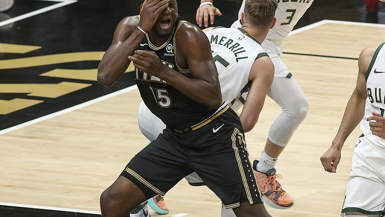 Jun 29, 2021; Atlanta, Georgia, USA; Atlanta Hawks center Clint Capela (15) reaches to being hit in his face against Milwaukee Bucks guard Sam Merrill (15) in the fourth quarter during game four of the Eastern Conference Finals for the 2021 NBA Playoffs at State Farm Arena. Mandatory Credit: Brett Davis-USA TODAY Sports
