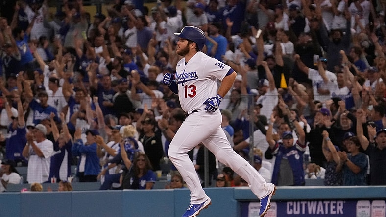 Jun 29, 2021; Los Angeles, California, USA; Fans cheer as Los Angeles Dodgers first baseman Max Muncy (13) rounds the bases after hitting a home run in the fourth inning against the San Francisco Giants at Dodger Stadium. Mandatory Credit: Robert Hanashiro-USA TODAY Sports