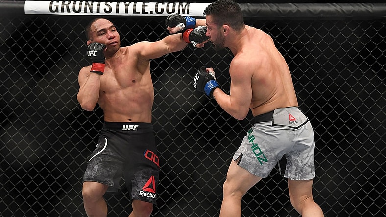 Mar 3, 2018; Las Vegas, NV, USA; John Dodson lands a hit against Pedro Munhoz during UFC 222 at T-Mobile Arena. Mandatory Credit: Stephen R. Sylvanie-USA TODAY Sports