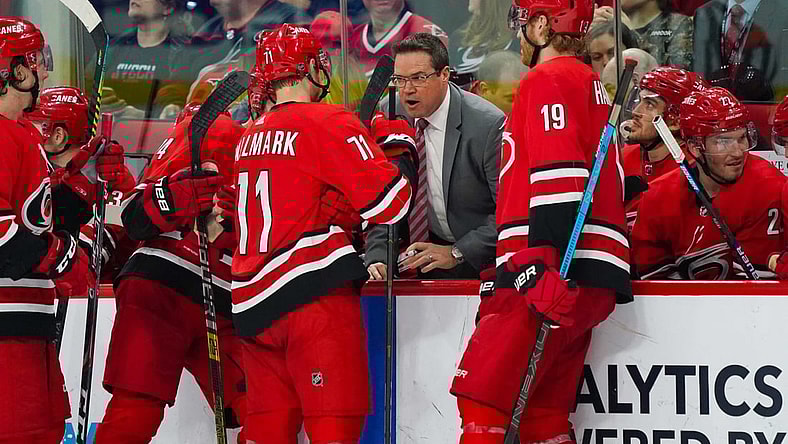 Apr 4, 2019; Raleigh, NC, USA;  Carolina Hurricanes assistant coach Dean Chynoweth talks to center Lucas Wallmark (71) and  defenseman Dougie Hamilton (19) during a time out against the New Jersey Devils at PNC Arena. The Carolina Hurricanes defeated the New Jersey Devils 3-1. Mandatory Credit: James Guillory-USA TODAY Sports