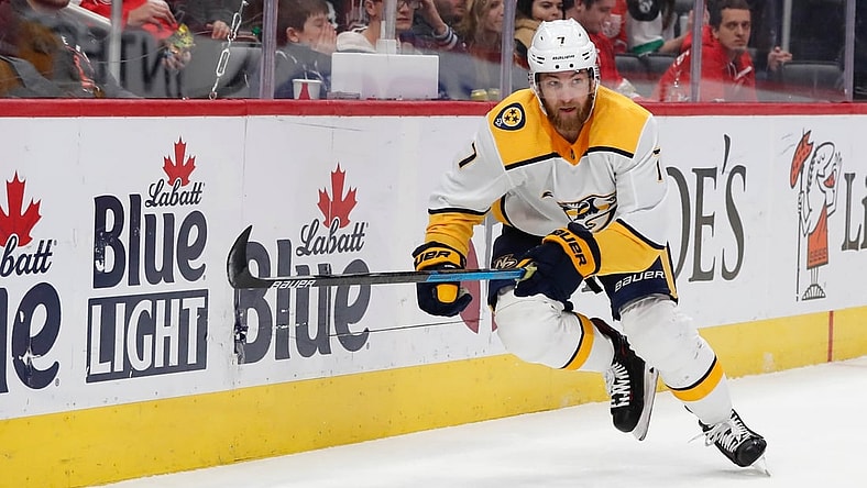 Nov 4, 2019; Detroit, MI, USA; Nashville Predators defenseman Yannick Weber (7) goes after the puck in the first period against the Detroit Red Wings at Little Caesars Arena. Mandatory Credit: Rick Osentoski-USA TODAY Sports