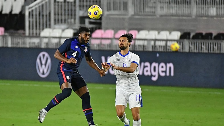 Dec 9, 2020; Fort Lauderdale, Florida, USA; United States defender Mark McKenzie (4) heads the ball in front of El Salvador forward Joaquin Rivas (11) during the second half at Inter Miami CF Stadium. Mandatory Credit: Jasen Vinlove-USA TODAY Sports