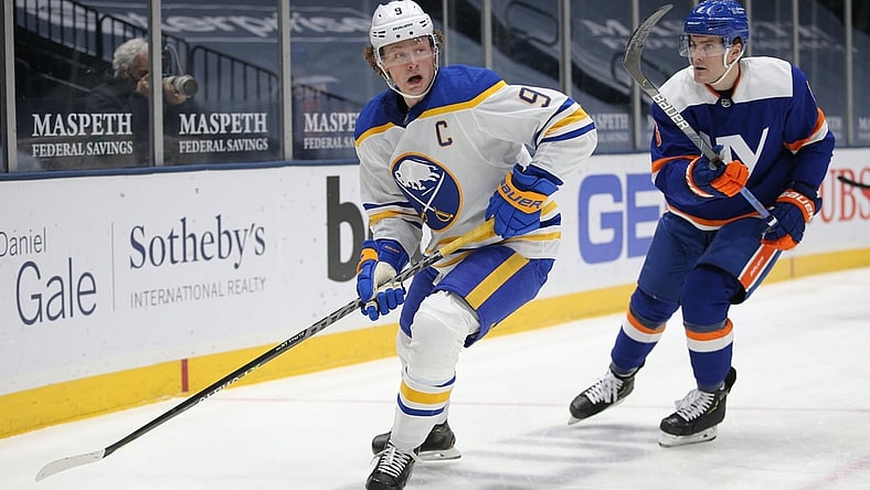 Mar 4, 2021; Uniondale, New York, USA; Buffalo Sabres center Jack Eichel (9) plays the puck against New York Islanders defenseman Ryan Pulock (6) during the first period at Nassau Veterans Memorial Coliseum. Mandatory Credit: Brad Penner-USA TODAY Sports