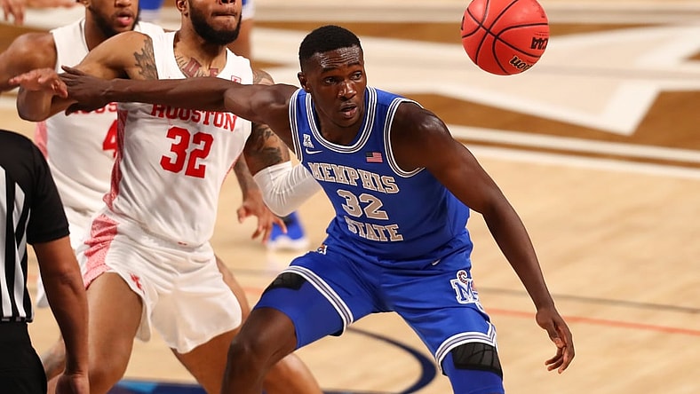 Mar 13, 2021; Fort Worth, TX, USA; Memphis Tigers center Moussa Cisse (32) tracks down a loose ball against Houston Cougars forward Reggie Chaney (32) during the first half at Dickies Arena. Mandatory Credit: Ben Ludeman-USA TODAY Sports
