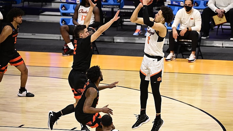 Mar 21, 2021; Indianapolis, Indiana, USA; Oklahoma State Cowboys guard Cade Cunningham (2) shoots while Oregon State Beavers guard Jarod Lucas (2) defends during the second half in the second round of the 2021 NCAA Tournament at Hinkle Fieldhouse. Mandatory Credit: Marc Lebryk-USA TODAY Sports
